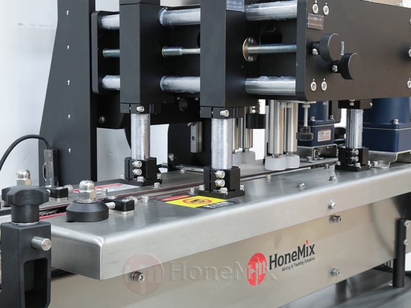 Four-Wheel-Capping-Unit-And-Conveyor-System-Close-Up