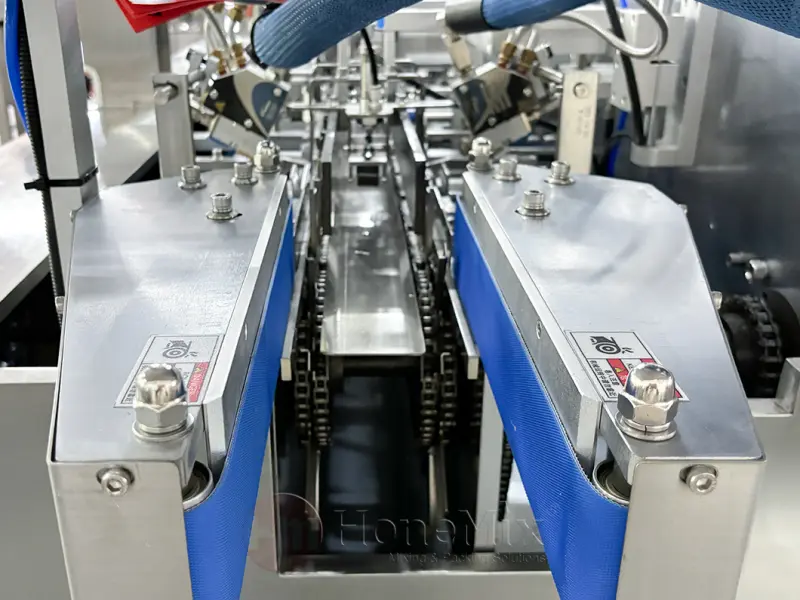 Conveyor system for tube and bottle cartoning machine