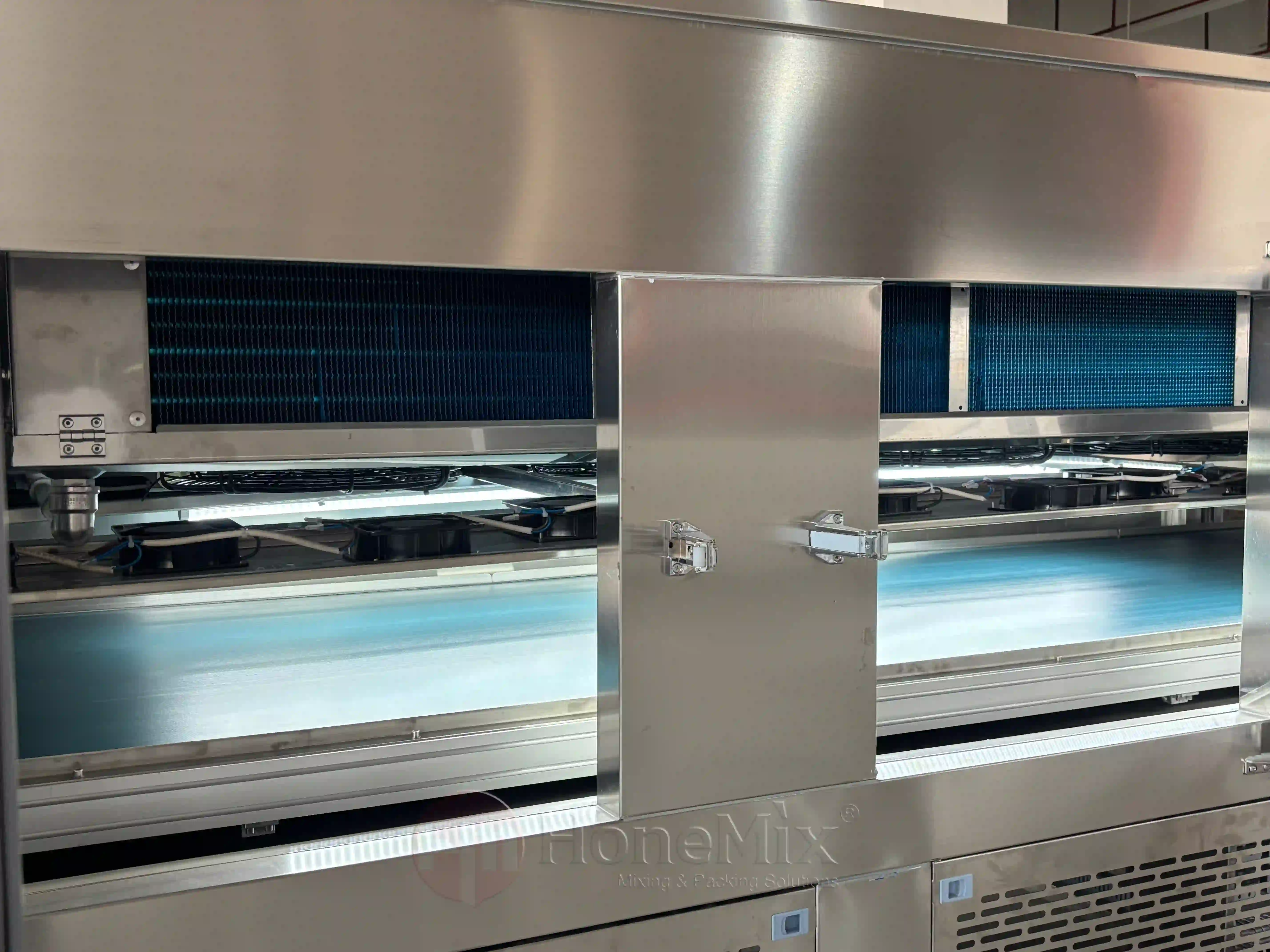 Cooling tunnel conveyor detail for filled petroleum jelly and lip balm jars